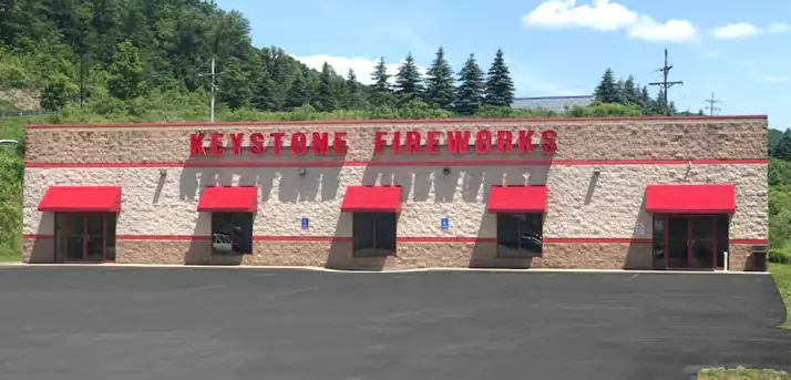 Keystone Bradford storefront with red awnings and the front lot