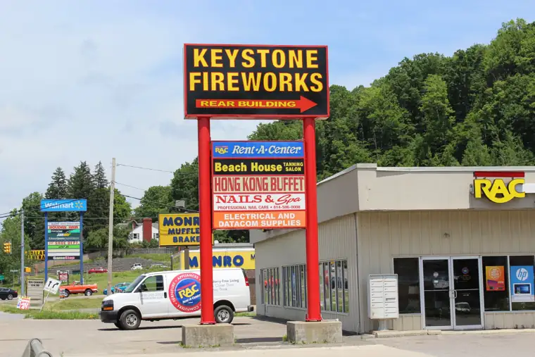 Tall red and yellow Keystone road sign on East Main Street