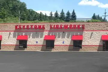 Keystone Bradford storefront with red awnings and the front lot