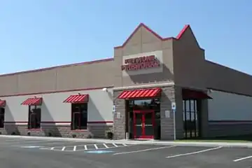 Keystone Greencastle storefront with red awnings and the front parking lot